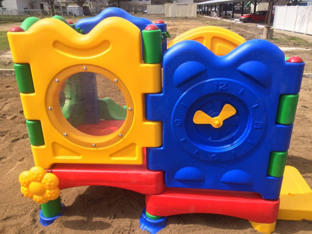 Side of play equipment for young children with a viewing window and a moveable clock