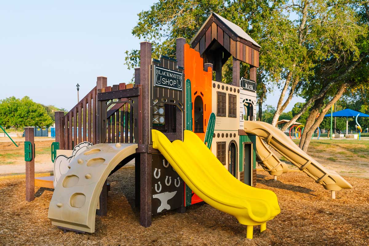 Angled view of a climbing ramp for a western-themed playground.